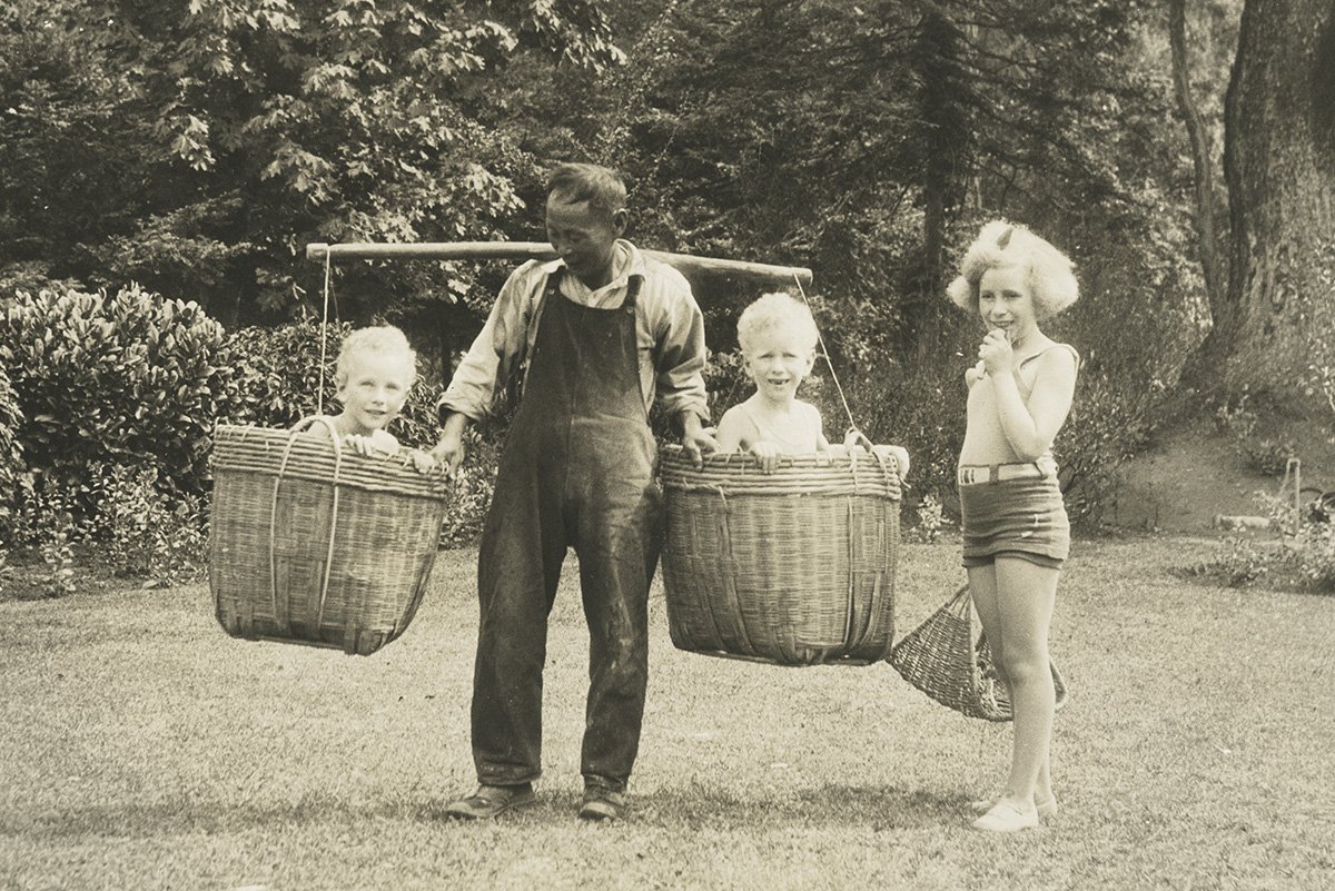 Bing carrying boys in basket in 1931